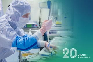 Person in cleanroom protective clothing pipettes